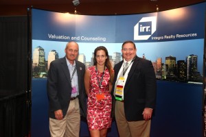 Integra attendees pose in front of the IRR booth.